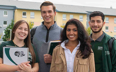 Diverse group of college students standing in front of Orchard Hall.