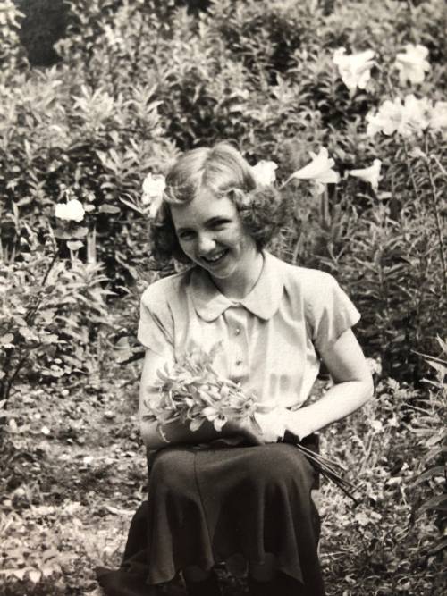 Claire Berg in her father's garden with flowers